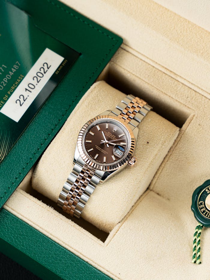 Home Elegant silver and gold watch in a luxury box with certificate detail, perfect gift idea.